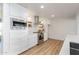 Updated kitchen featuring sleek white cabinets, stainless steel appliances, and wood-style floors at 541 W Marlette Ave, Phoenix, AZ 85013