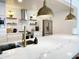 Open kitchen showcases a large marble countertop island, stylish pendant lighting, and modern stainless steel appliances at 541 W Marlette Ave, Phoenix, AZ 85013