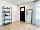 Bright living room features wood-look flooring, modern décor, and a decorative mirror and shelving at 541 W Marlette Ave, Phoenix, AZ 85013