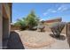 View of the backyard showing mature trees and desert landscaping at 5418 W Carson Rd, Laveen, AZ 85339