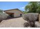 Backyard view of the home with covered patio and desert landscaping at 5418 W Carson Rd, Laveen, AZ 85339