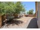 Spacious backyard featuring mature trees, a brick border, and a gravel ground cover at 5418 W Carson Rd, Laveen, AZ 85339