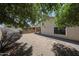 View of the backyard showing the exterior of the home, including a covered patio at 5418 W Carson Rd, Laveen, AZ 85339