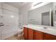 Well-lit bathroom with a large mirror, and a shower-tub combination at 5418 W Carson Rd, Laveen, AZ 85339