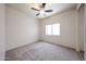Bright bedroom featuring neutral carpet, ceiling fan, and a window at 5418 W Carson Rd, Laveen, AZ 85339