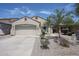 Charming single-story home with two car garage and desert landscaping at 5418 W Carson Rd, Laveen, AZ 85339