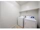 Functional laundry room with washer, dryer, and tile flooring at 5418 W Carson Rd, Laveen, AZ 85339