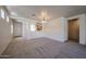 Spacious living room featuring neutral carpeting, open layout, and easy access to the kitchen at 5418 W Carson Rd, Laveen, AZ 85339