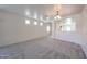 Bright living room showcasing neutral carpet, natural light, and easy access to other rooms at 5418 W Carson Rd, Laveen, AZ 85339
