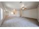 Spacious living room with neutral carpeting, open layout, and a seamless transition to other areas at 5418 W Carson Rd, Laveen, AZ 85339