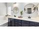 Well-lit bathroom features dual sinks, modern fixtures, and a spacious vanity at 6317 S Banning St, Gilbert, AZ 85298