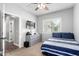 Cozy bedroom featuring a striped bed, dresser, TV, and natural light at 6317 S Banning St, Gilbert, AZ 85298