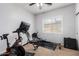 This bedroom has workout equipment, a ceiling fan, and a window with natural light at 6317 S Banning St, Gilbert, AZ 85298