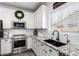 Well-appointed kitchen with granite countertops, stainless steel appliances, and a farmhouse sink at 6317 S Banning St, Gilbert, AZ 85298
