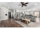 Open-concept living area with wood floors, a cozy sectional, and seamless kitchen access at 6317 S Banning St, Gilbert, AZ 85298