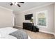 Comfortable primary bedroom suite with a TV, side table, and window at 6317 S Banning St, Gilbert, AZ 85298