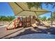 Playground featuring a covered play area with slides and climbing structures at 6317 S Banning St, Gilbert, AZ 85298
