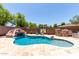 Backyard pool with slide, rock features, and travertine deck at 6317 S Banning St, Gilbert, AZ 85298