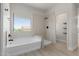 Modern bathroom featuring a soaking tub, shower, and neutral tile at 742 W Vineyard Plains Dr, San Tan Valley, AZ 85143