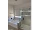 Modern bathroom featuring a sleek glass shower and a soaking tub near a window at 742 W Vineyard Plains Dr, San Tan Valley, AZ 85143