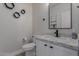 Contemporary powder room with granite countertop, modern fixtures, and hexagonal wall decor at 742 W Vineyard Plains Dr, San Tan Valley, AZ 85143