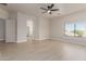 Open bedroom with light wood floors, recessed lights, and a glimpse of the attached bathroom at 742 W Vineyard Plains Dr, San Tan Valley, AZ 85143