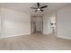 Spacious bedroom with light wood floors and a view into the adjacent bathroom and closet at 742 W Vineyard Plains Dr, San Tan Valley, AZ 85143