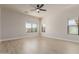 Bright, empty bedroom with light wood floors, a ceiling fan, and ample natural light at 742 W Vineyard Plains Dr, San Tan Valley, AZ 85143