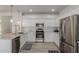 Modern kitchen features white cabinets, stainless steel appliances, and granite countertops at 742 W Vineyard Plains Dr, San Tan Valley, AZ 85143