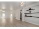 Spacious living room featuring wood-look floors, and modern shelving at 742 W Vineyard Plains Dr, San Tan Valley, AZ 85143