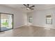 Bright bedroom with wood-look floors, windows, and sliding glass door at 742 W Vineyard Plains Dr, San Tan Valley, AZ 85143