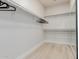 Bright walk-in closet featuring built-in shelving, closet rods, and a mirror at 742 W Vineyard Plains Dr, San Tan Valley, AZ 85143