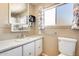 Bathroom featuring a white sink, toilet, and mirror at 8103 E Southern Ave # 170, Mesa, AZ 85209
