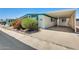 Charming home featuring a covered carport, mature landscaping, and appealing light blue trim at 8103 E Southern Ave # 170, Mesa, AZ 85209