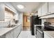 Efficient kitchen featuring stainless steel appliances and white cabinets with a view to living area at 8103 E Southern Ave # 170, Mesa, AZ 85209