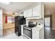 Bright kitchen featuring white cabinetry, and a black refrigerator and stove at 8103 E Southern Ave # 170, Mesa, AZ 85209