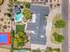 Overhead view of luxury home showing roofline, landscaping, pool, sport court, and outdoor living areas at 8213 E Sharon Dr, Scottsdale, AZ 85260