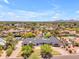 Stunning aerial view of a luxury home nestled in a lush community with mountain views at 8213 E Sharon Dr, Scottsdale, AZ 85260