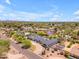 Scenic aerial view of a home surrounded by lush trees in a suburban neighborhood with mountain views at 8213 E Sharon Dr, Scottsdale, AZ 85260