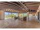 Large covered patio with brick flooring and lounge seating, overlooking the landscaped backyard at 8213 E Sharon Dr, Scottsdale, AZ 85260