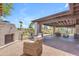 Spacious covered patio featuring an outdoor fireplace with ample seating, ideal for relaxing outdoors at 8213 E Sharon Dr, Scottsdale, AZ 85260