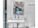 Well-lit half-bathroom featuring a chrome sink and modern fixtures, exuding simplistic elegance at 8213 E Sharon Dr, Scottsdale, AZ 85260