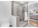 Bathroom with glass shower, toilet and view to primary bedroom at 8213 E Sharon Dr, Scottsdale, AZ 85260