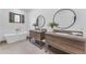 Bright bathroom featuring dual sinks with modern fixtures and a freestanding bathtub under window at 8213 E Sharon Dr, Scottsdale, AZ 85260