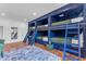 Fun bunkroom with custom built-in bunks, wooden floors, and inviting decor at 8213 E Sharon Dr, Scottsdale, AZ 85260