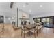 Elegant dining area featuring a large wooden table, stylish chairs, and a rustic fireplace accent at 8213 E Sharon Dr, Scottsdale, AZ 85260