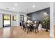 Dining room with a long table, seating for six, and natural light and door to outside at 8213 E Sharon Dr, Scottsdale, AZ 85260
