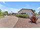 Long paver driveway leads to an elegant home with bright stucco and mature landscaping at 8213 E Sharon Dr, Scottsdale, AZ 85260