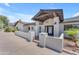 Covered front patio with stylish seating area, leading to a bright and welcoming entryway at 8213 E Sharon Dr, Scottsdale, AZ 85260