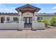 Inviting front entrance with modern lighting and a covered patio, perfect for welcoming guests at 8213 E Sharon Dr, Scottsdale, AZ 85260